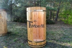 Outdoor wooden shower positioned externally from the outdoor sauna